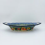 Iris Meadow oval platter with handles, straight-on side view showing cutout handles and exterior floral band