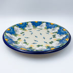 UNIKAT Blue Petal Dance plate, front view showing blue and white daisy ring on scalloped rim