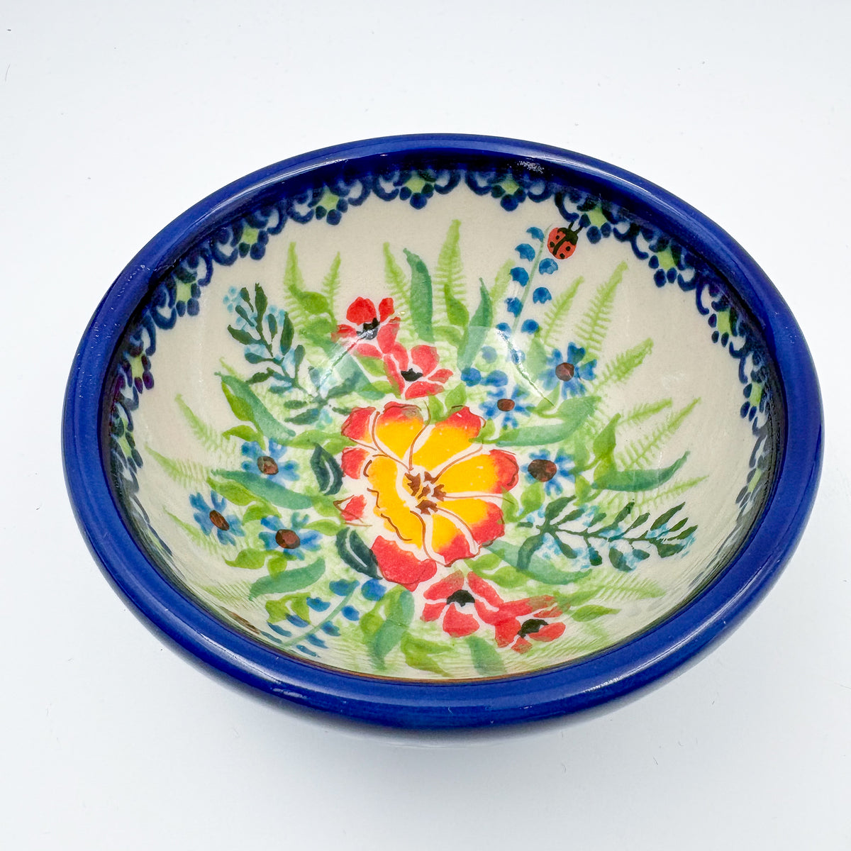 Angled view of largest bowl in Ladybug Fields stacking set