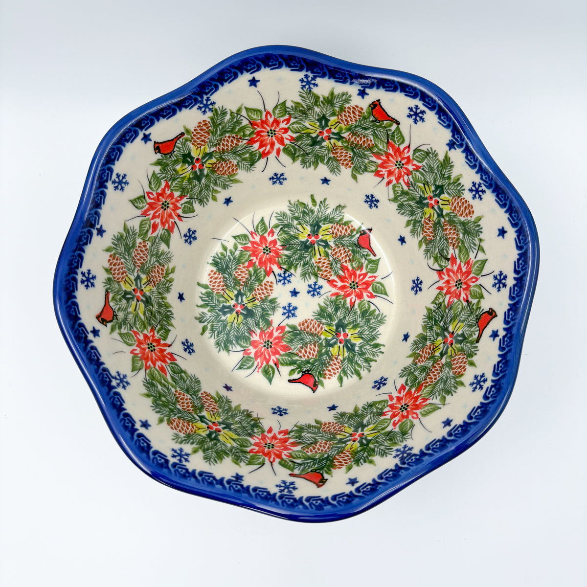 Christmas Cardinals wavy bowl, top-down view showing double wreath of poinsettias, pinecones, and cardinals