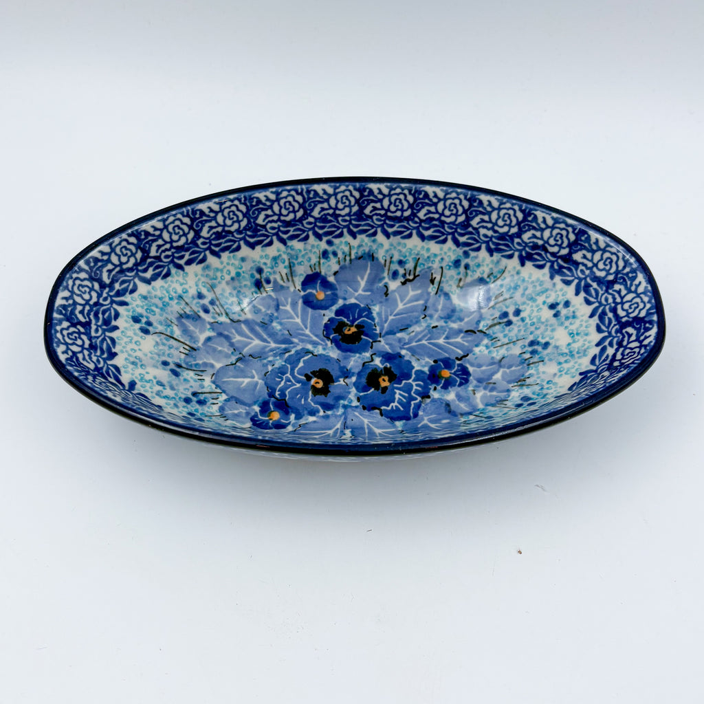 UNIKAT Deep Winter oval bowl, front view showing blue pansy bouquet with rose border
