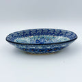 UNIKAT Deep Winter oval bowl, front view on oval foot showing blue pansy pattern and floral rim band