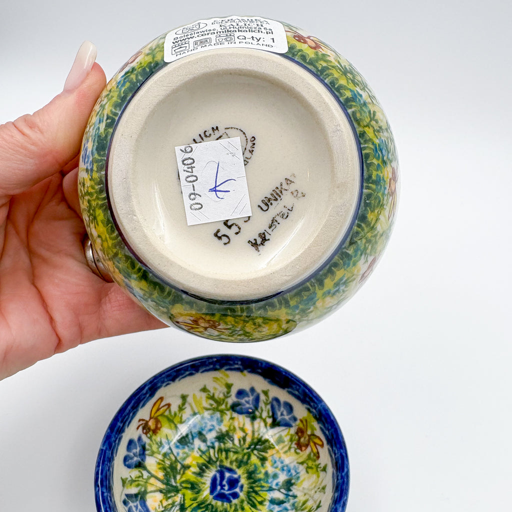 Bottom of largest Bluebell Meadow bowl showing Kalich Unikat stamp and artist signature, held in hand