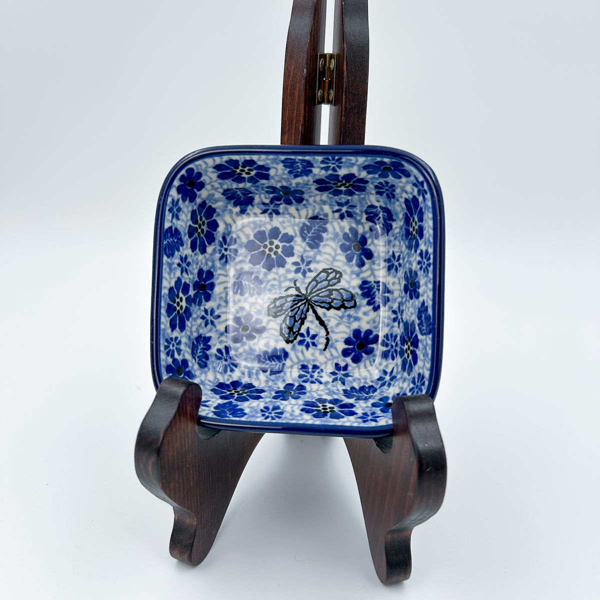 Misty Dragonfly square bowl, front view displayed on wooden stand showing dragonfly pattern