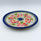 UNIKAT Cherry Blossom plate, front view showing red cherries and pink blossoms on scalloped rim