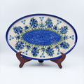 UNIKAT Blueberry oval tray, front view on stand showing blueberry clusters and mosaic center band