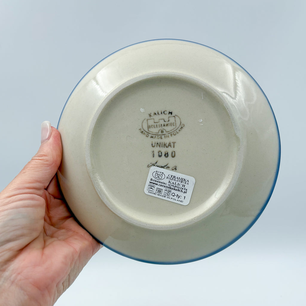 UNIKAT Cherry Blossom plate held in hand, bottom stamp with Kalich Boleslawiec Unikat mark