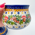 Iza sugar bowl, Mushroom Design, close-up side view held in hand showing mushroom and berry wreath