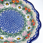 Close-up angled view of center medallion and floral border on Cottage Garden Kora bowl