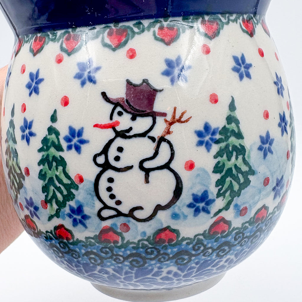 Close-up of snowman design on Snowman Stroll bubble mug, held in hand