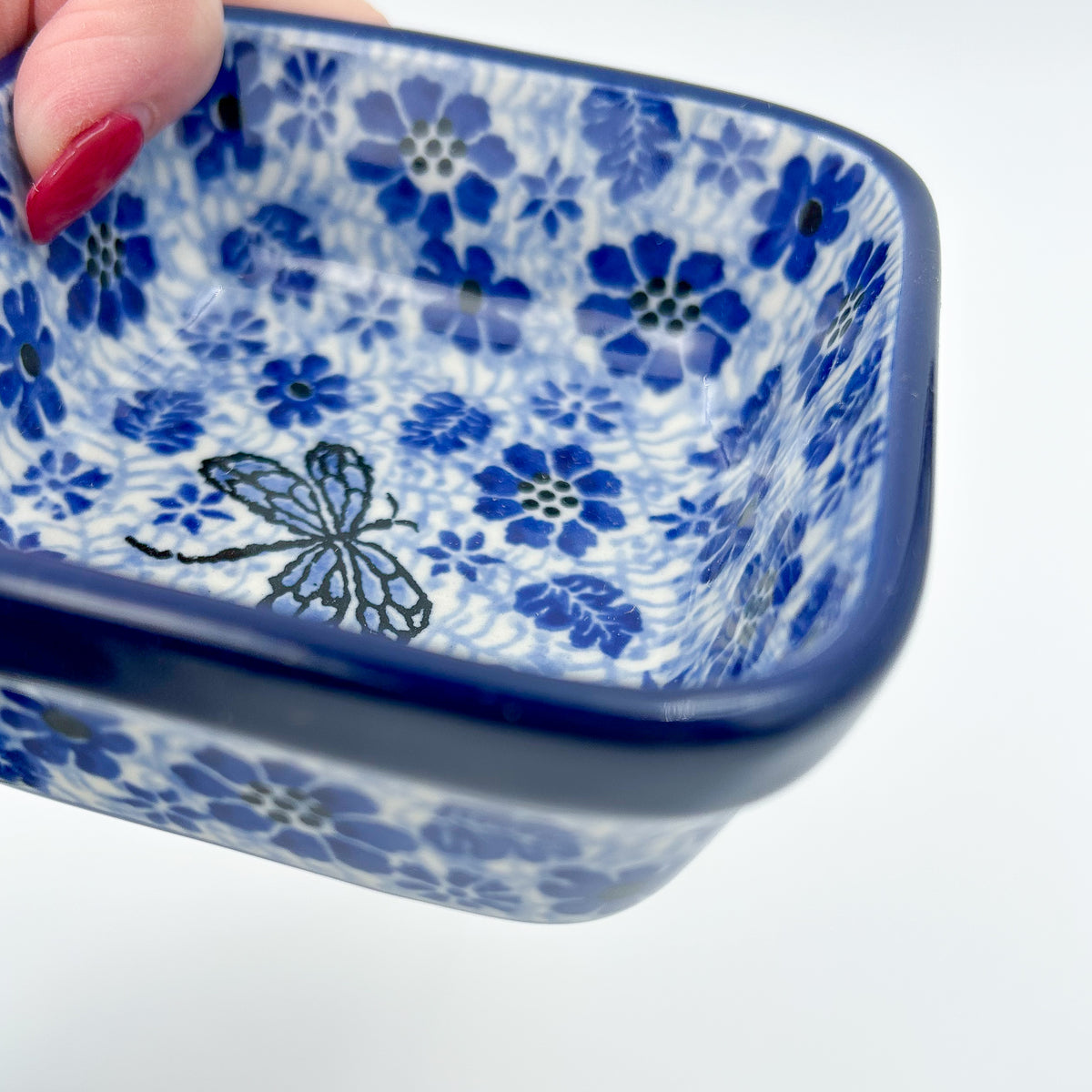 Misty Dragonfly square bowl, close-up interior view held in hand showing dragonfly and blue floral pattern