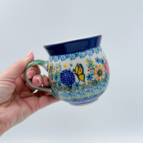 Butterfly Garden bubble mug held in hand, front view