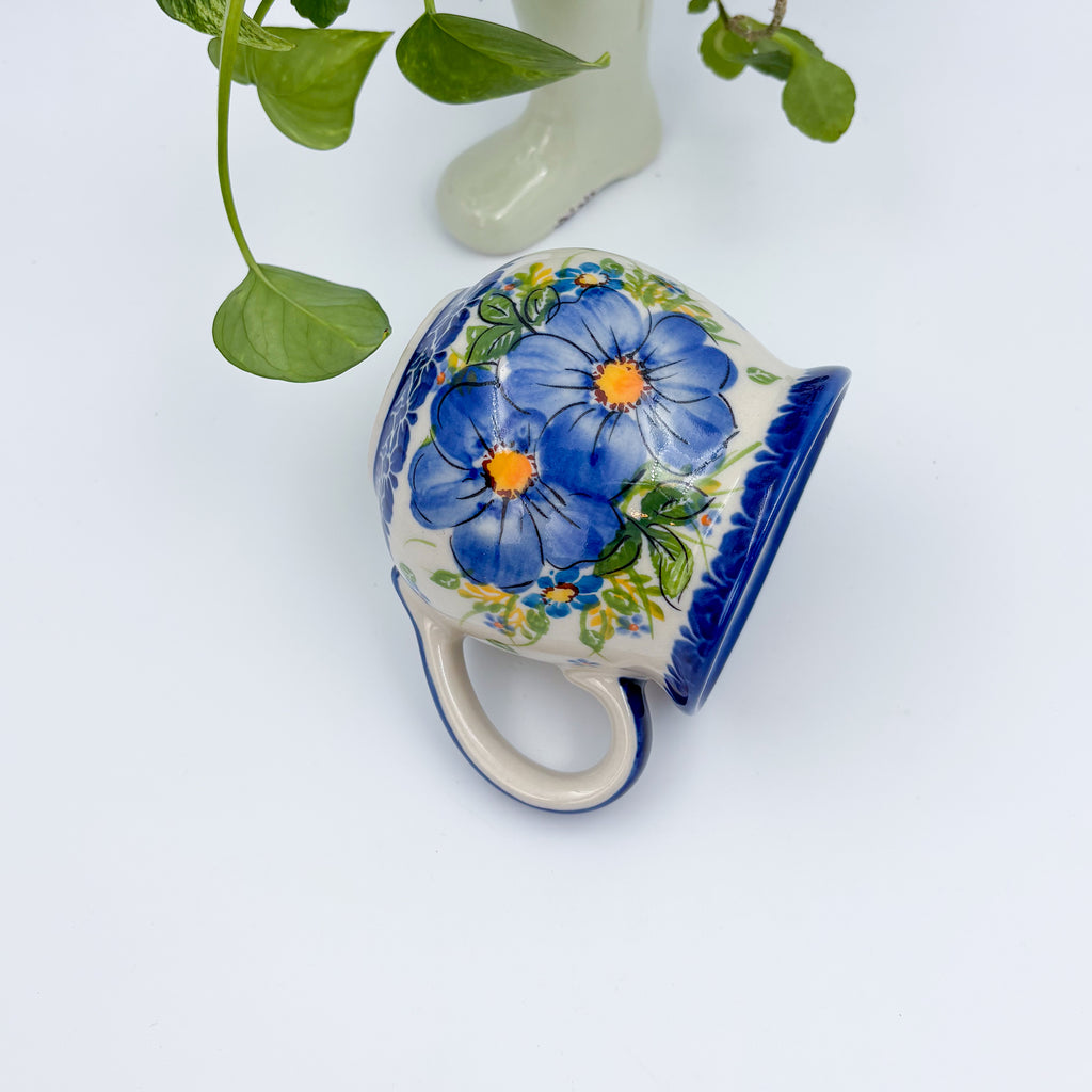Blue Pansy bubble mug tipped on its side showing painted pansy pattern