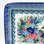 Mariposa rectangular platter, close-up corner view showing scroll border layers and floral bouquet edge