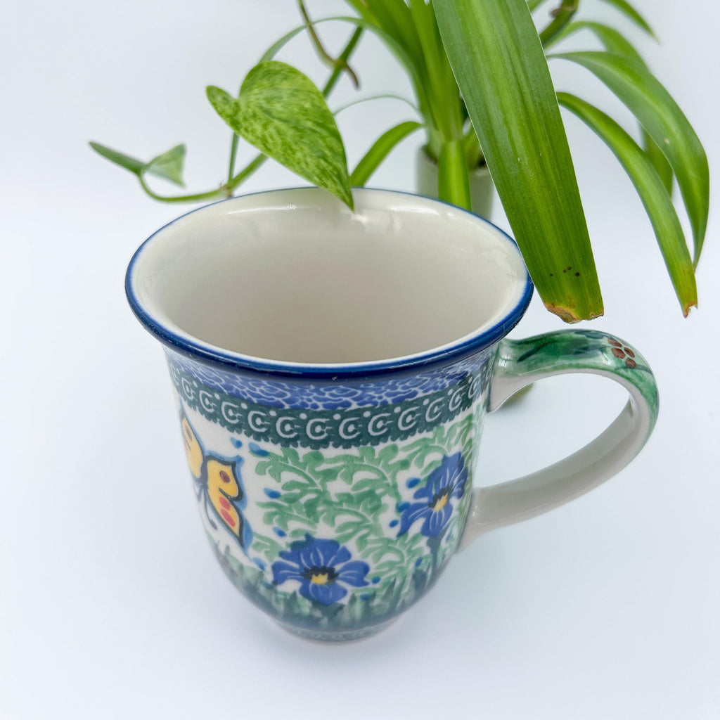 Spring Garden bistro mug, angled top view with plant in background