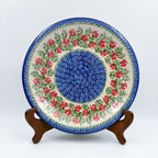 Midsummer Bloom plate, front view displayed on wooden stand showing red flower ring around blue center