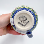 Bottom of Pink Ruffle bubble mug showing Kalich Unikat stamp, held in hand