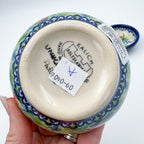Bottom of largest Ladybug Fields bowl showing Kalich Unikat stamp, held in hand