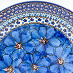 UNIKAT Cobalt Poppies plate, close-up rim detail showing scalloped border pattern above blue poppies