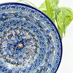 Close-up angled view of center medallion on Fields of Blue stacking bowl