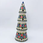 UNIKAT Roseberry Cottage Christmas tree luminary, front view of tiered cone shape with pierced holes, roses, and berries
