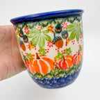 Hedgehog and Pumpkins Viking mug held in hand, alternate front view