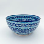 Corn in the Blue deep bowl on white background, front view showing star geometric pattern