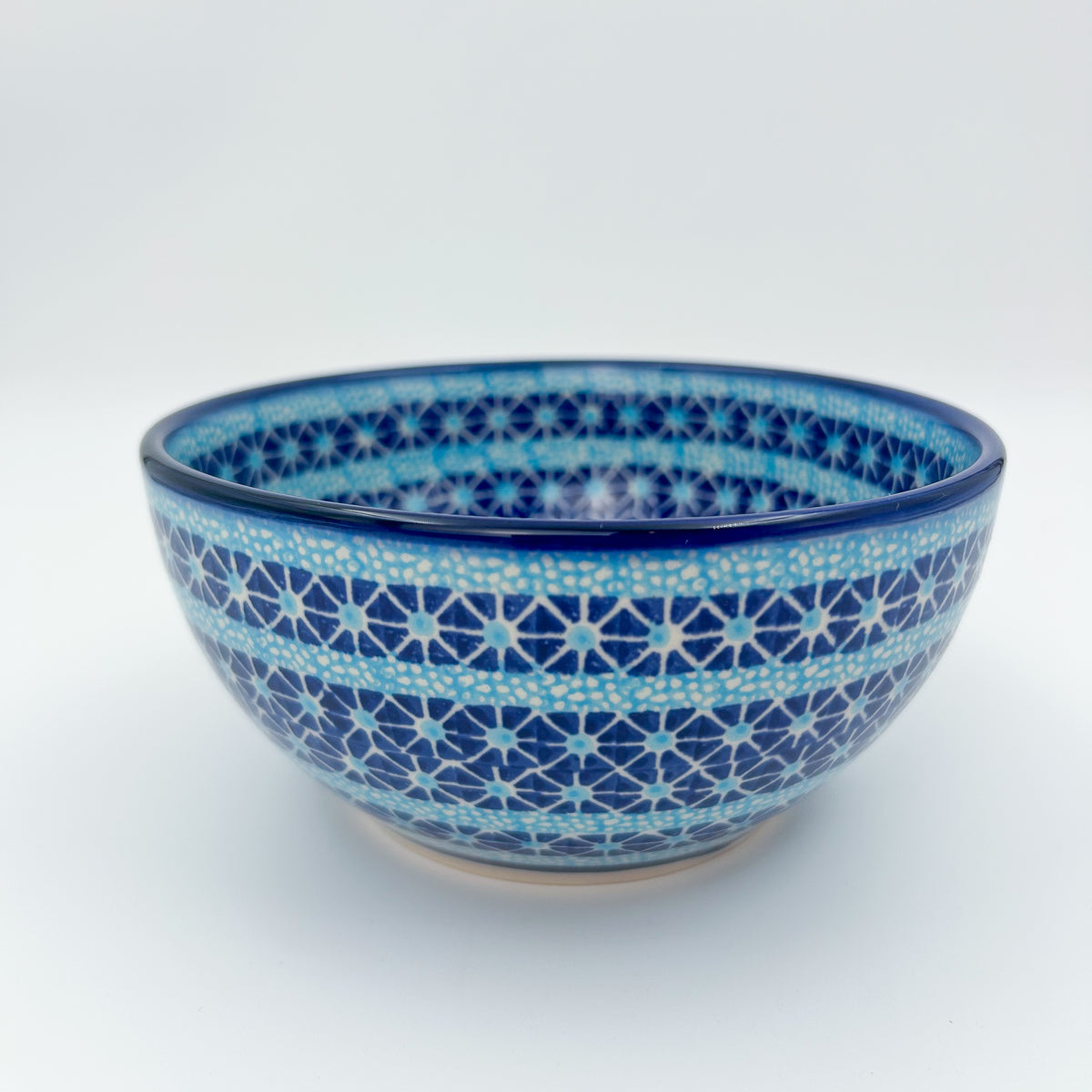Corn in the Blue deep bowl on white background, front view showing star geometric pattern