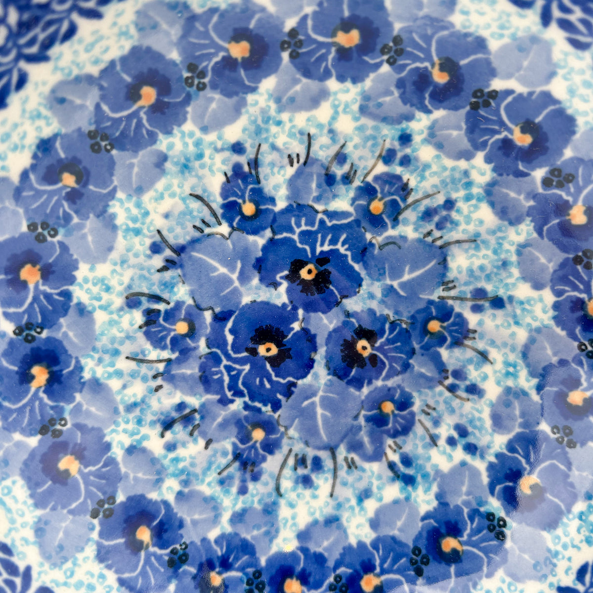 Close-up of pansy medallion center on Deep Winter scalloped bowl