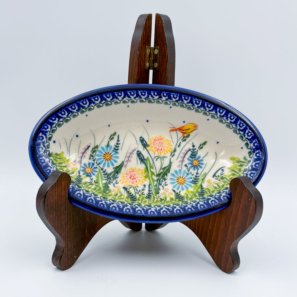 UNIKAT Songbird Garden oval Milano platter, front view on stand showing garden flowers and orange songbird