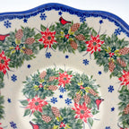 Christmas Cardinals wavy bowl, top-down view held in hand showing full wreath pattern
