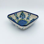 Blueberries square bowl on white background, angled front view showing depth