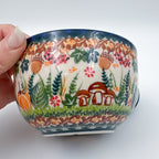Close-up of mushrooms and acorns on Hedgehog and Acorns latte mug, held in hand