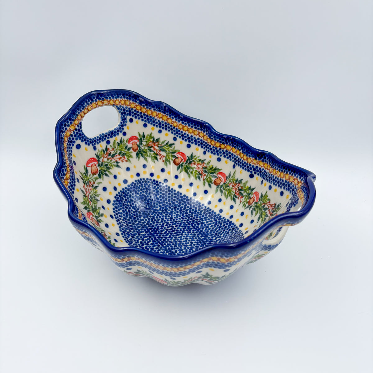 UNIKAT Mushroom Pattern Lodka bowl with handles, angled top-down view of mushroom wreath and blue dotted well