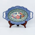 Iris Meadow oval platter with handles, front view on stand showing floral bouquet center