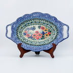 Iris Meadow oval platter with handles, front view on stand showing floral bouquet center