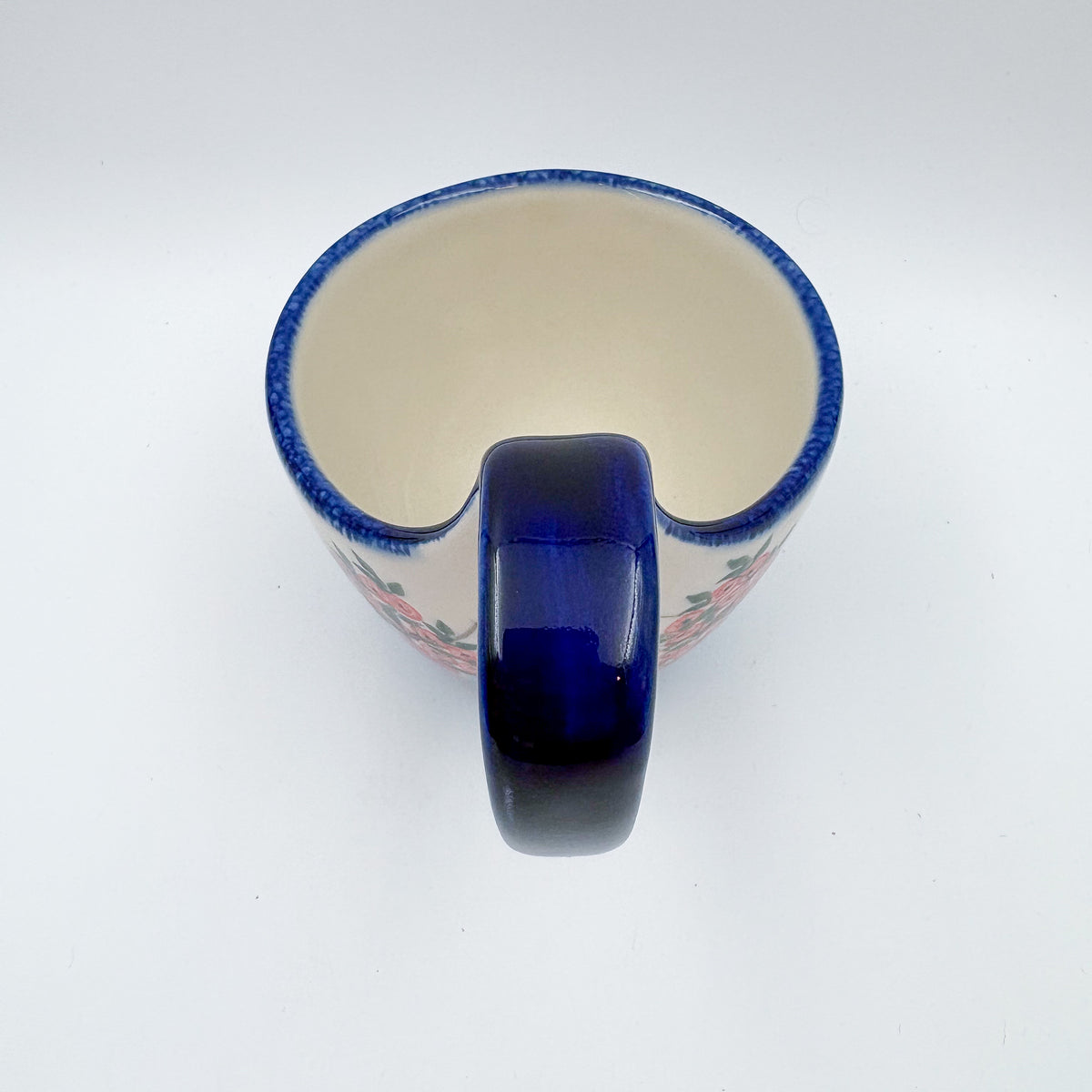 Top-down view into Red Berry loop-handle bowl mug showing interior and handle