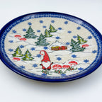 UNIKAT Gnome Village plate, front view showing gnome, snowy cabin, and pine trees scene