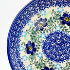 UNIKAT Blue Floral Day plate, close-up rim view of blue flowers and mosaic center