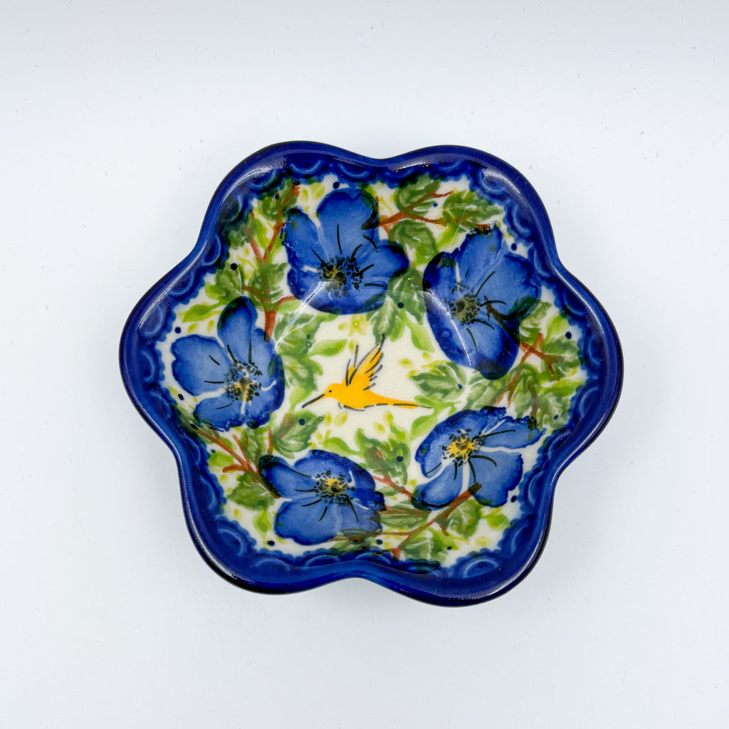 Blue Poppy Songbird flower-shaped bowl on white background, top-down view