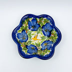 Blue Poppy Songbird flower-shaped bowl on white background, top-down view