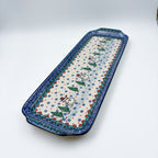 UNIKAT Snowman Stroll rectangular platter, angled top-down view of full platter with snowmen and pine trees