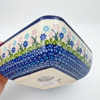 Blueberries square bowl held in hand, exterior side view