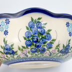 Close-up of scalloped exterior rim showing blueberry clusters on Blueberry Kora bowl