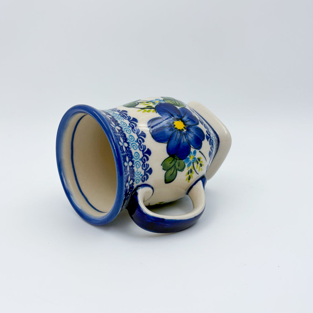 Blue Poppy tulip mug tipped on its side showing interior and pattern