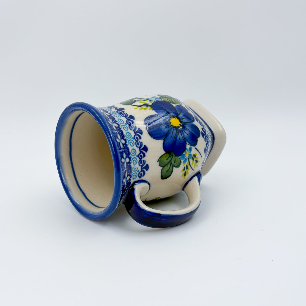 Blue Poppy tulip mug tipped on its side showing interior and pattern