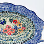 Iris Meadow oval platter with handles, close-up rim detail of blue scroll border and floral bouquet