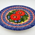 UNIKAT Red Finesy plate, angled front view showing red poppy cluster on scalloped rim