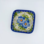 Blue Daisy square bowl on white background, top-down straight-on view