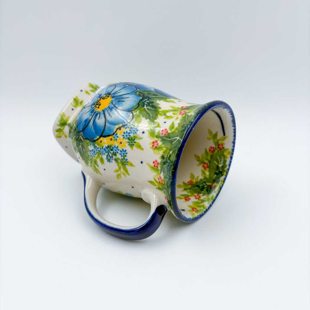 Blue Poppy Dance tulip mug tipped on its side, alternate angle showing interior and pattern